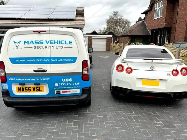 Branded Mass Vehicle Security van parked beside a Nissan GT-R after a mobile installation